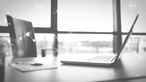 animation of molecules moving over laptop on desk