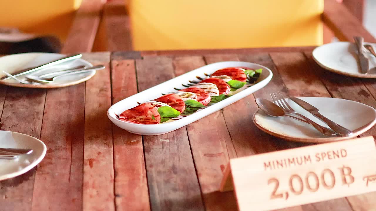 Caprese salad displayed with minimum spend sign