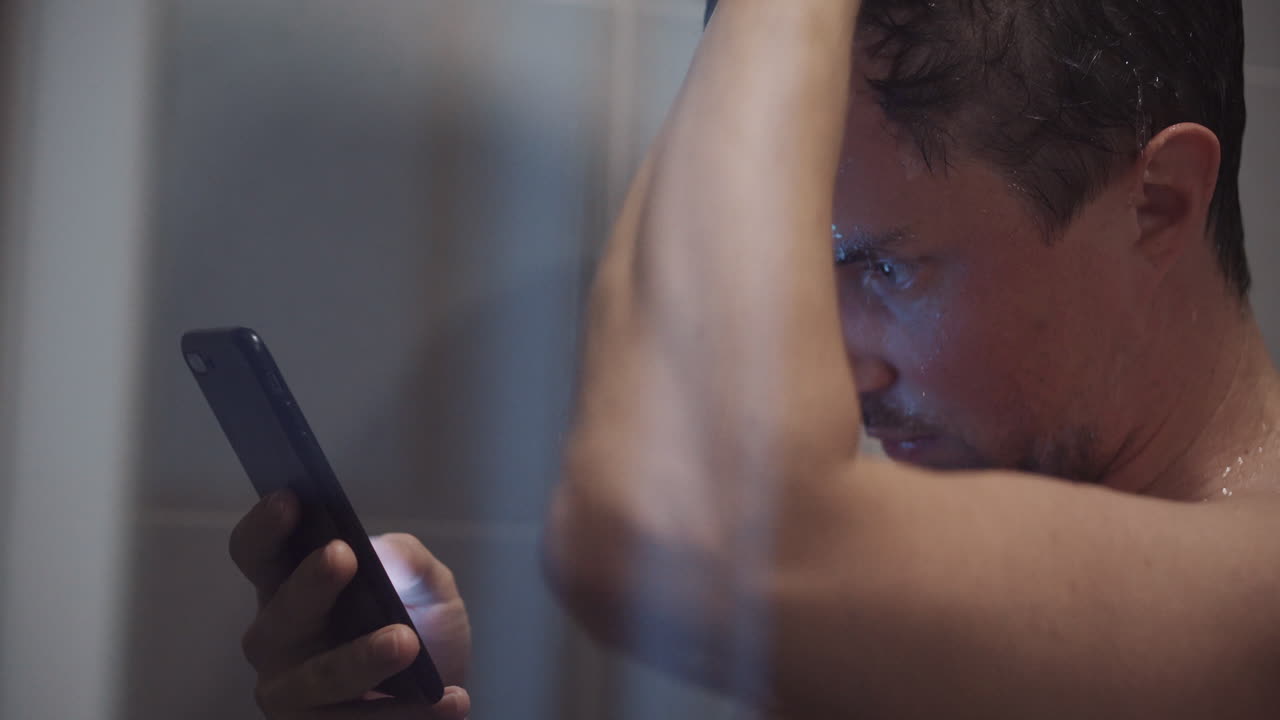 Man using phone in the shower