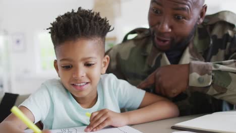 african american father with son learning together and writing