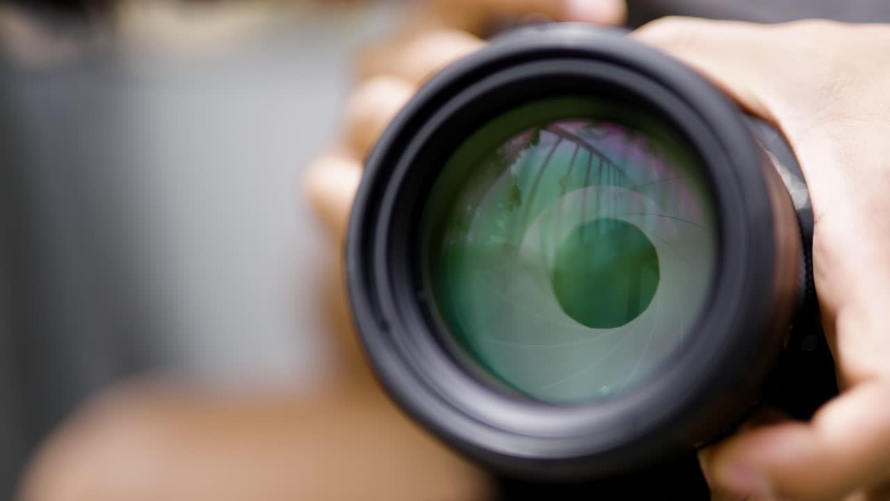 Lens Aperture opening Close-Up of Photographer Changing Iris and Aperture on Camera Lens