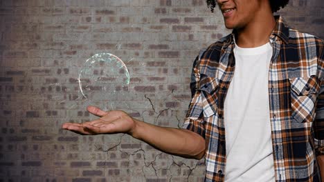 man holding globe against brick wall 4k