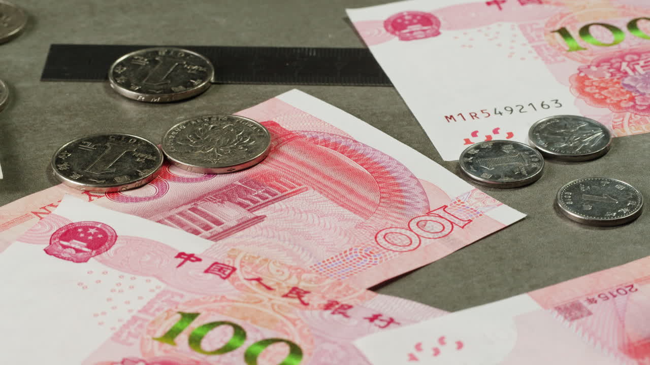 Chinese Yuan Currency with Coins and Ruler