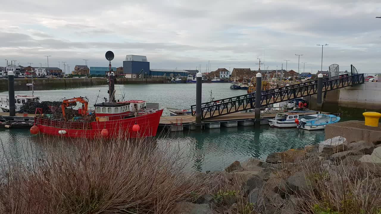 Small pier with fisher boats in Howth