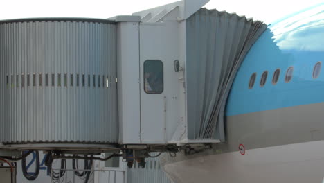 people leaving the plane through jet bridge