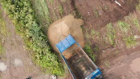 dump truck loading sand in construction site