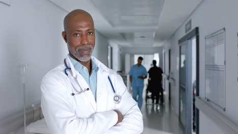 portrait of happy african american male doctor wearing lab coat and stethoscope, slow motion