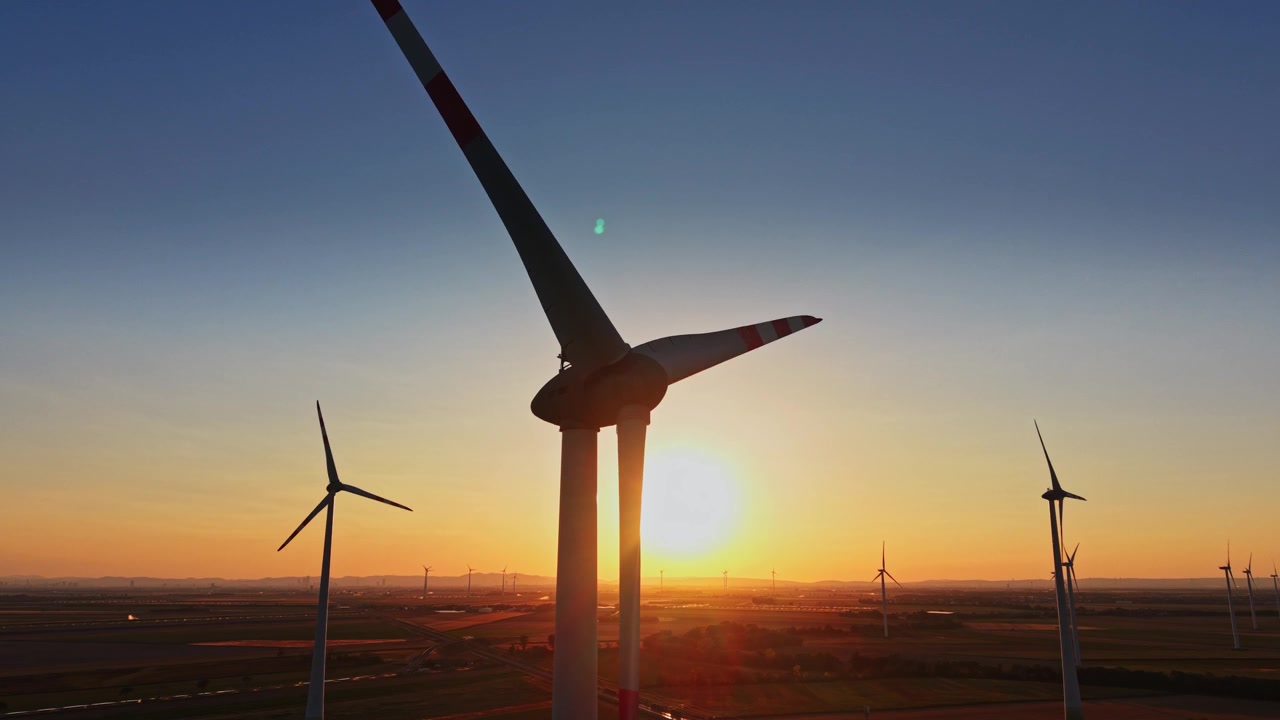 Sunset view of wind turbines in a large field