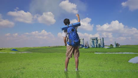 man hiking and looking at stonehenge