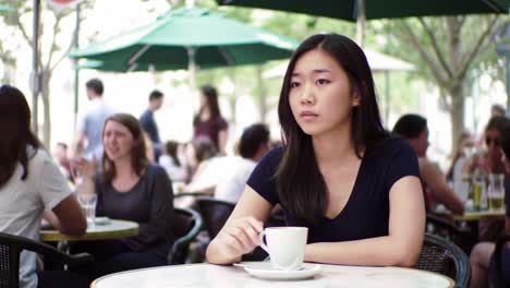 woman enjoying coffee in an outdoor cafe