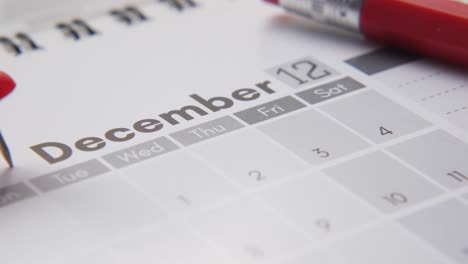 december 2023 calendar with red pen and pushpin