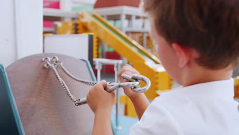 young boy doing practical puzzle at science activity centre