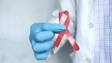 doctor holding a red awareness ribbon