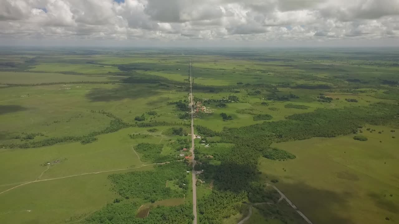 Vista dall'alto di una lunga strada dritta attraverso una savana verde