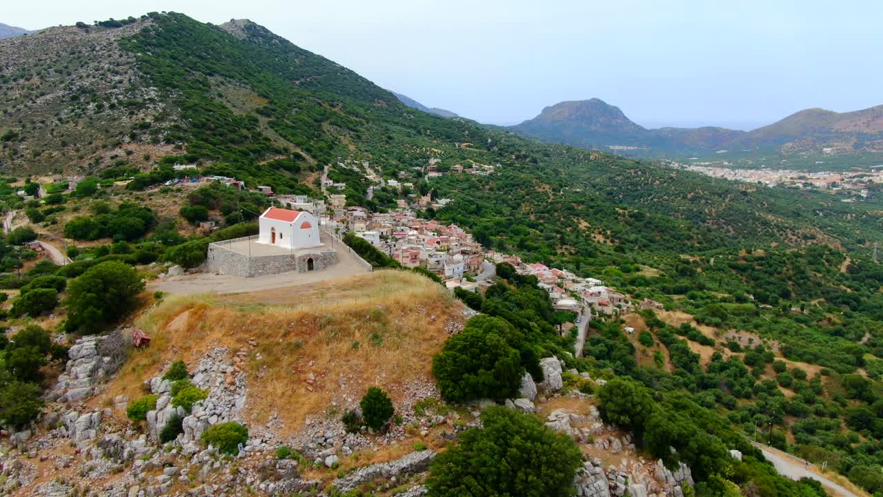 A drone shot of Island Crete with small town in the mountain