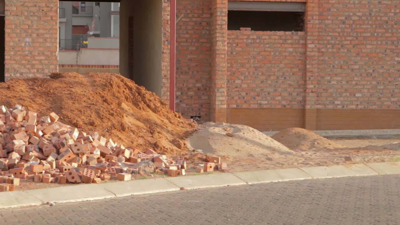 벽돌과 모래 작업이 진행 중인 새 주택 건설 현장 팬