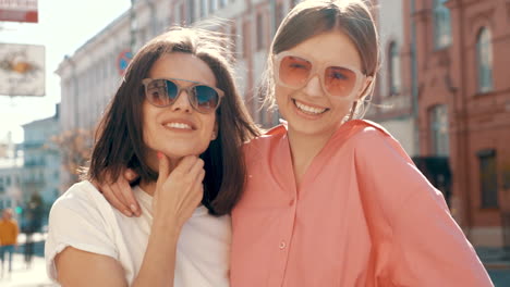 two happy friends posing on the street