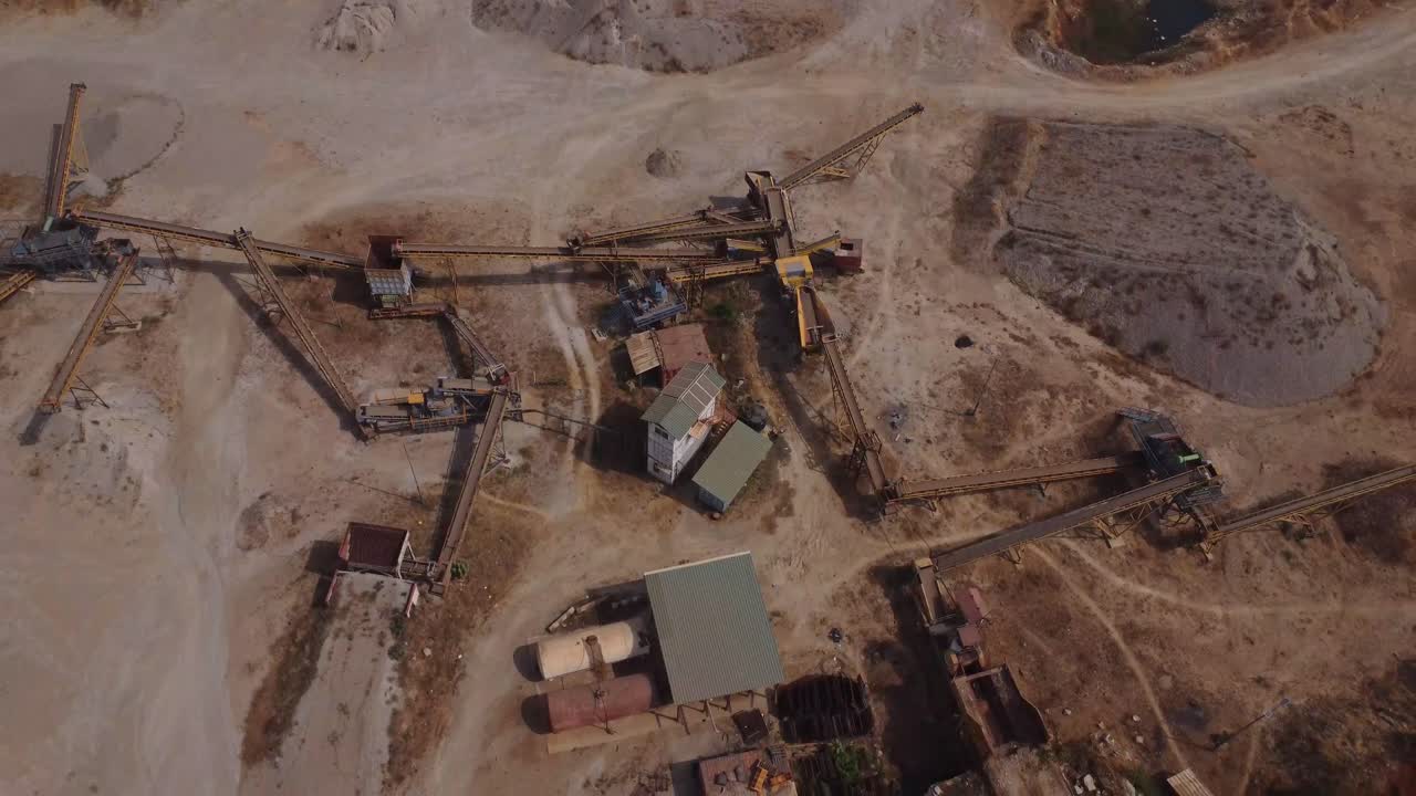Beautiful jib down of a beautiful industrial sand quarry with mining equipment in Nigeria on a sunny day