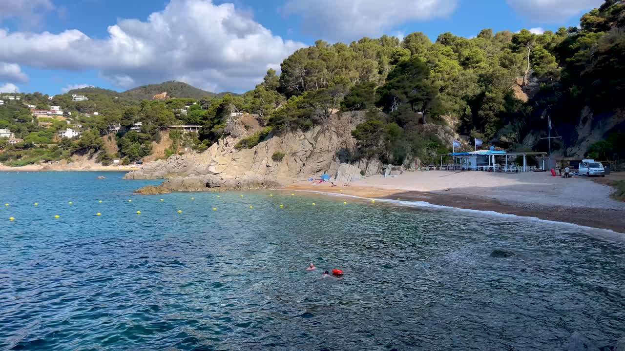 Costa Brava beautiful virgin beach with transparent turquoise waters lush vegetation Gerona Catalonia Mediterranean Panoramic views Tossa de Mar cove Llevad?
