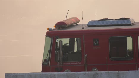 fire truck illuminated with large smoke cloud