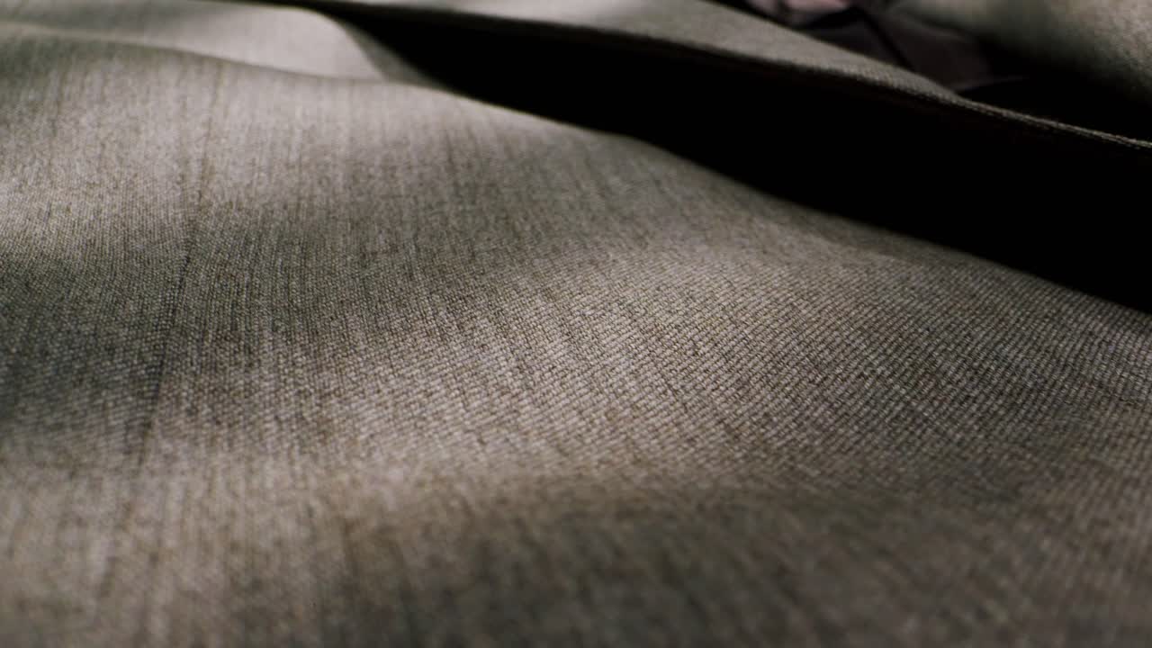 Closeup of an expertly tailored suit that beautifully showcases its sophisticated buttons and fine fabric texture