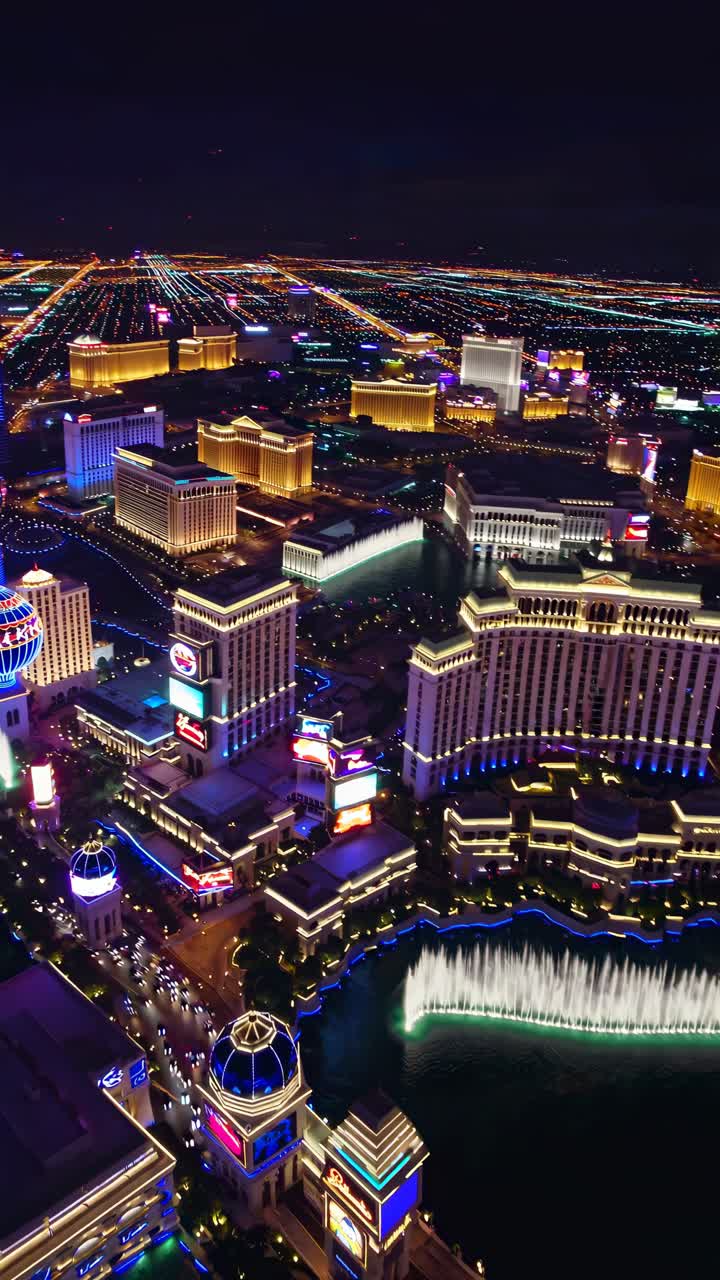 Aerial video view of vibrant Las Vegas Strip at night, showcasing illuminated hotels and streets