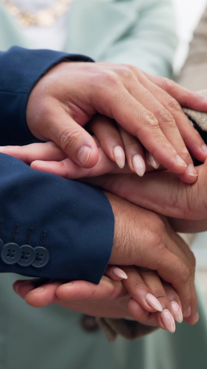Business Team Stacking Hands in Unity and Celebration