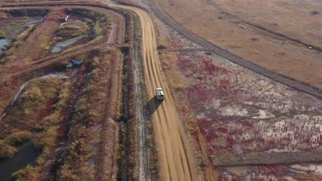 un camión blanco corriendo entre plantas nativas en tierras recuperadas