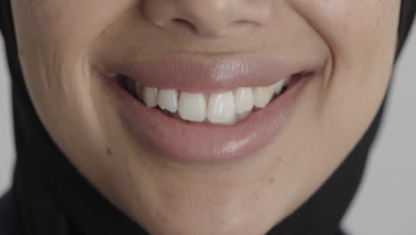 close-up-woman-mouth-smiling-happy-satisfaction-middle-eastern-female-wearing-hijab-healthy-teeth