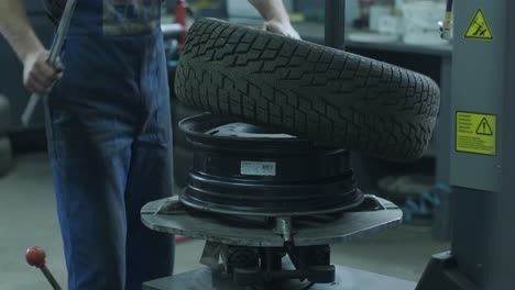 tire service. alignment of car rims. tire machine for rolling and alignment of steel wheel rims close-up