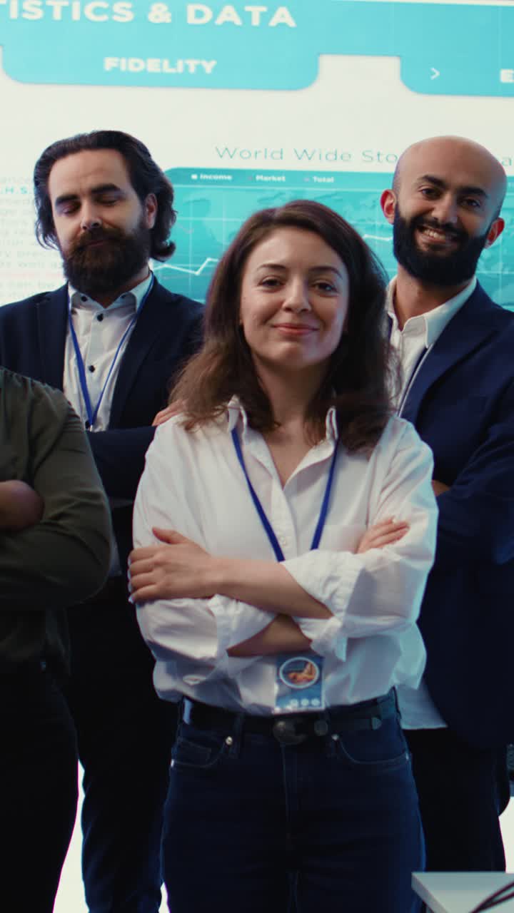 Equipe de negócios confiante posando em frente a telas de dados financeiros