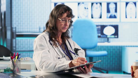 vertical video medical specialist explaining diagnostics through test results with old patient