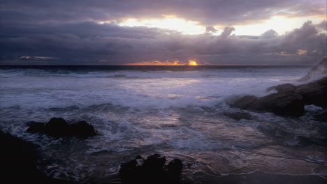 Dramatic-seascape-view-with-dark-clouds-and-waves-crashing-against-rocks