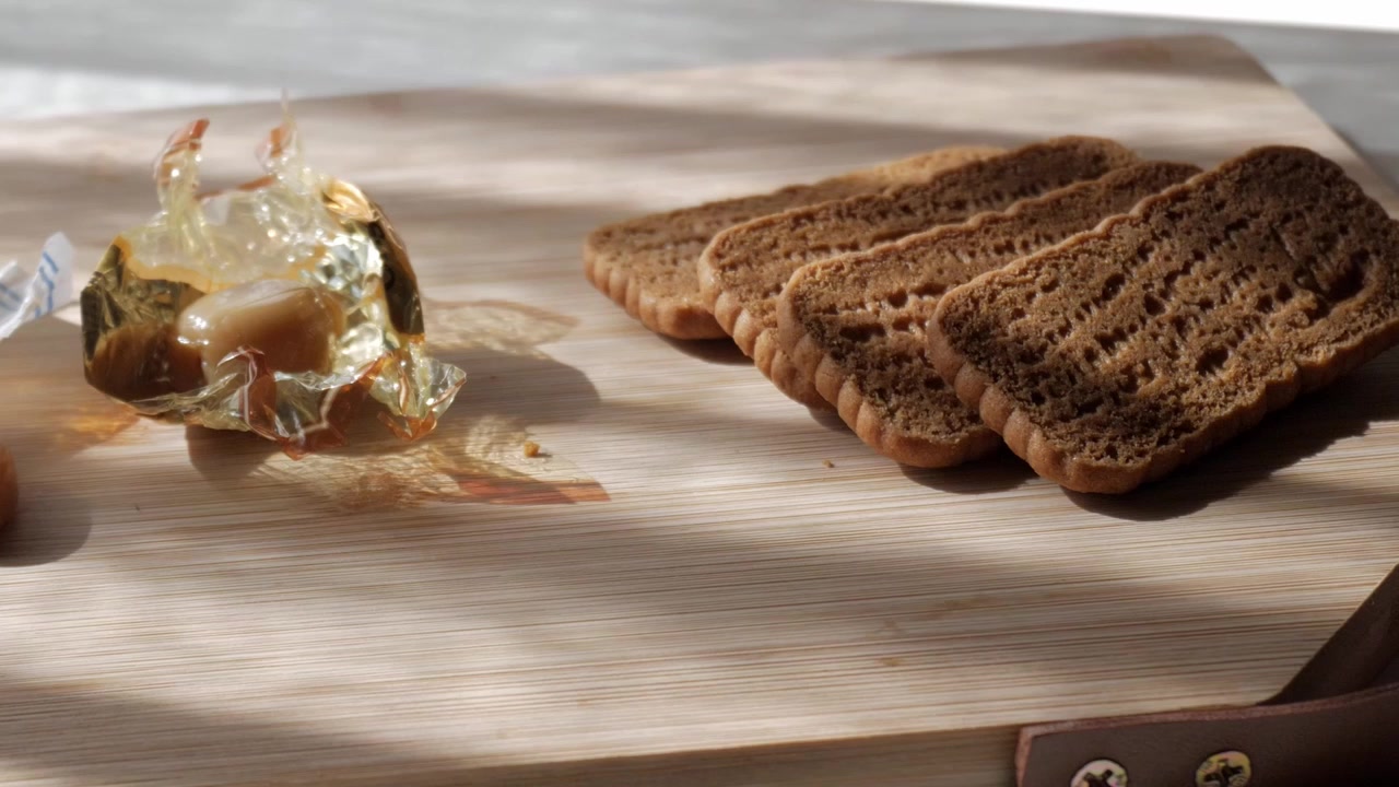 Crisp Lotus biscuit slices with honey evoke cozy morning vibes.Toffee caramel sweets (Werther like).