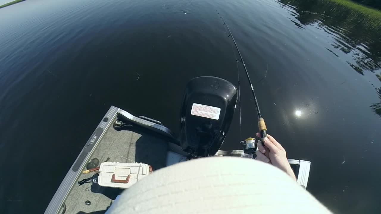 POV Of Man Fishing With A Fishing Rod From A Boat