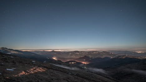 Twilight-mountain-view-with-starry-sky-and-valley-lights,-timelapse