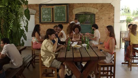 Friends and Diverse Group Socializing at a Bar with Live Music