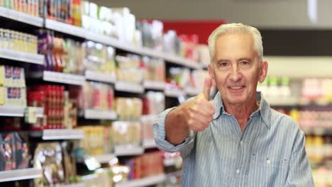 Senior-man-showing-thumbs-up-at-grocery-store