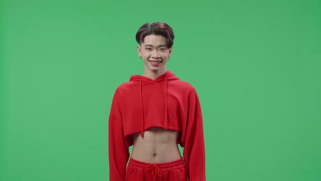 Young Asian Transgender Male Warmly Smiling On Green Screen Background In The Studio