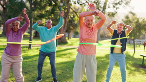 seniors exercising with hula hoops in the park
