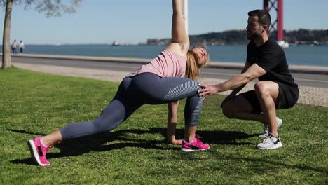 mujer deportiva calentándose con el entrenador antes del entrenamiento.