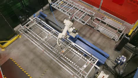 timelapse above a robotic welder working on a steel frame