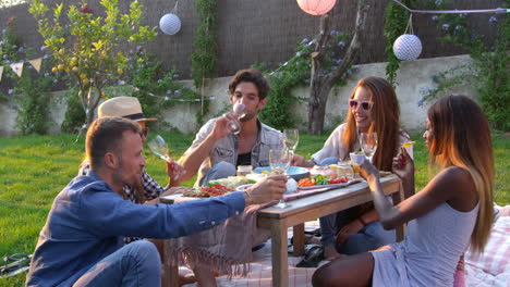 group of friends enjoying outdoor picnic in garden