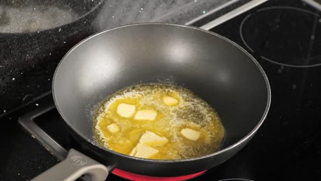 close-up of a kitchen pan of boiling butter and oil