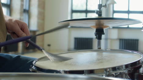 close up of playing drum with drum brushes