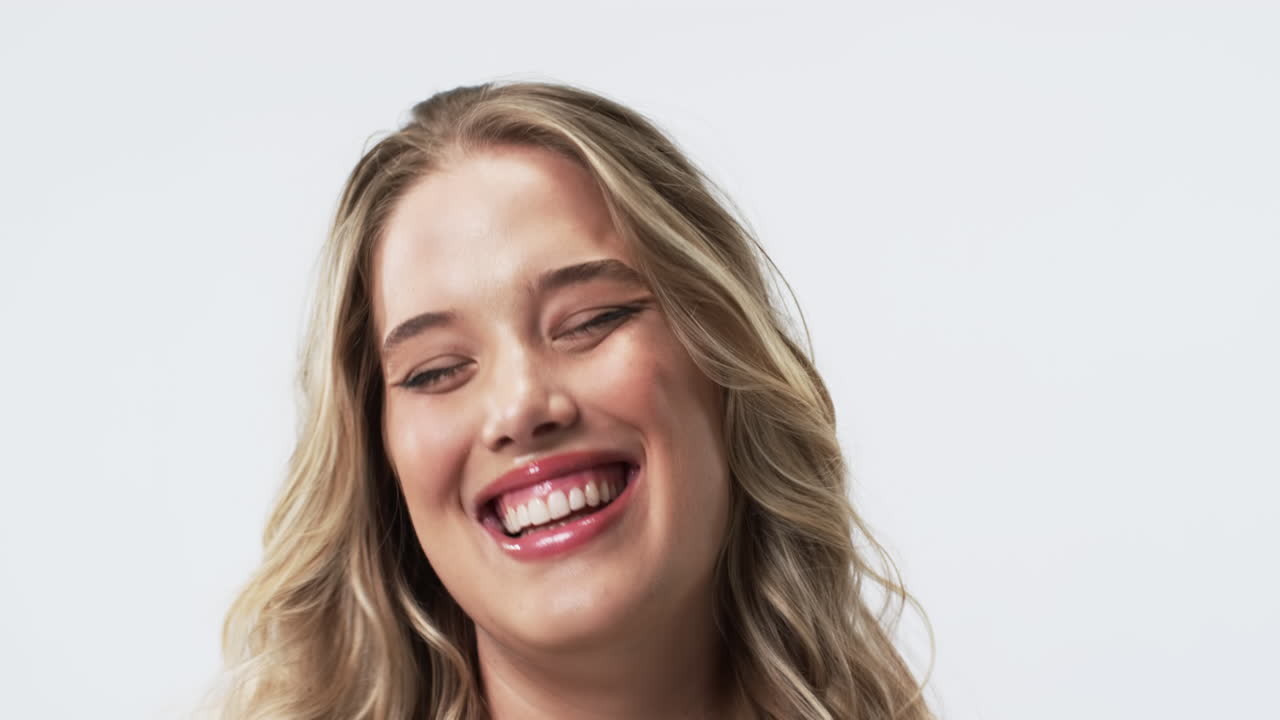 Young Caucasian plus size woman with long blonde hair and blue eyes smiling