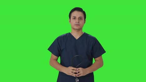 Sad-Indian-doctor-removing-stethoscope-from-shoulders-Green-screen