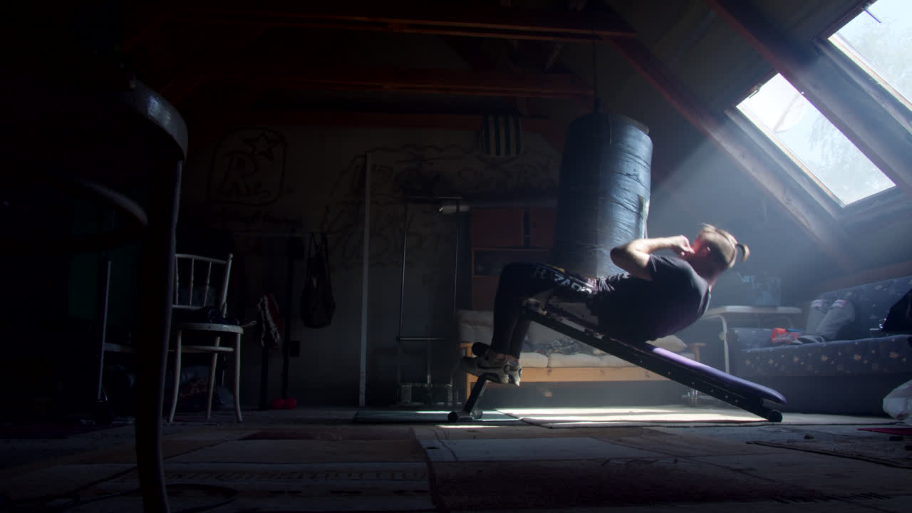 Man Working Out in an Attic Home Gym