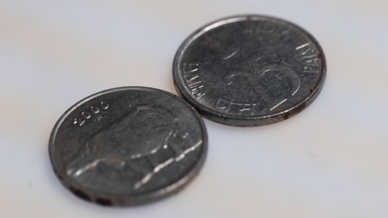 Indian discontinued 25 paise coin currency on white background. parallax shot, 4k.