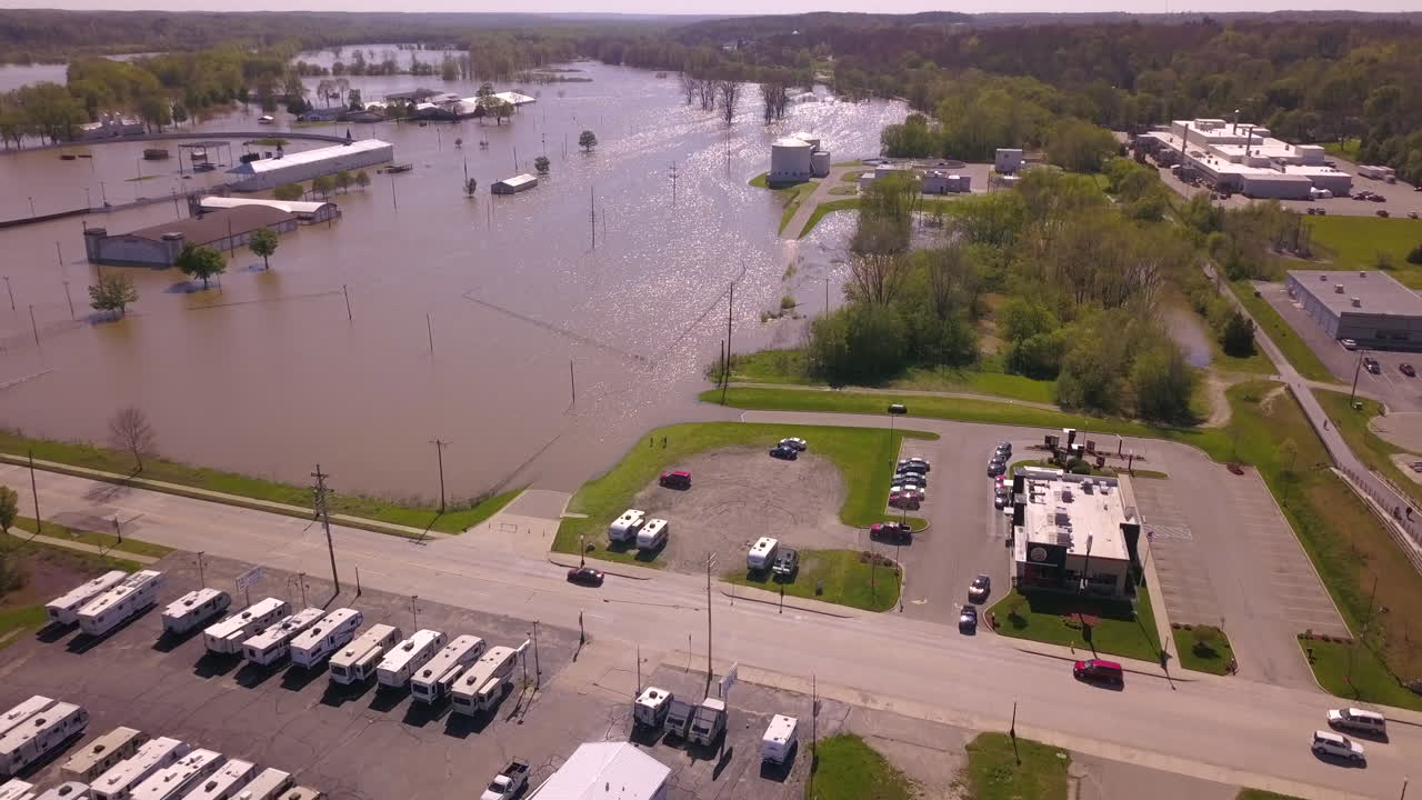 Aerial shot of car traffic by flooded County Fair area in Ionia, Michigan